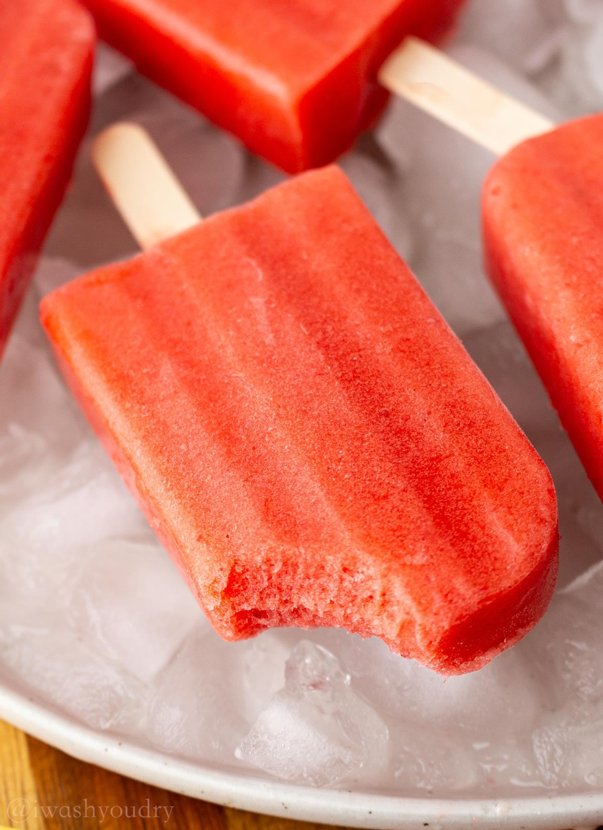 bite taken out of strawberry popsicle.