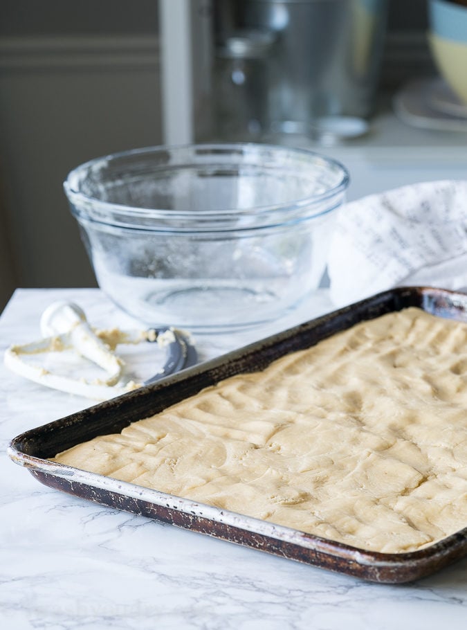 These Fluffy Sugar Cookie Cake Bars start out in a large baking sheet and only take a few minutes to bake!