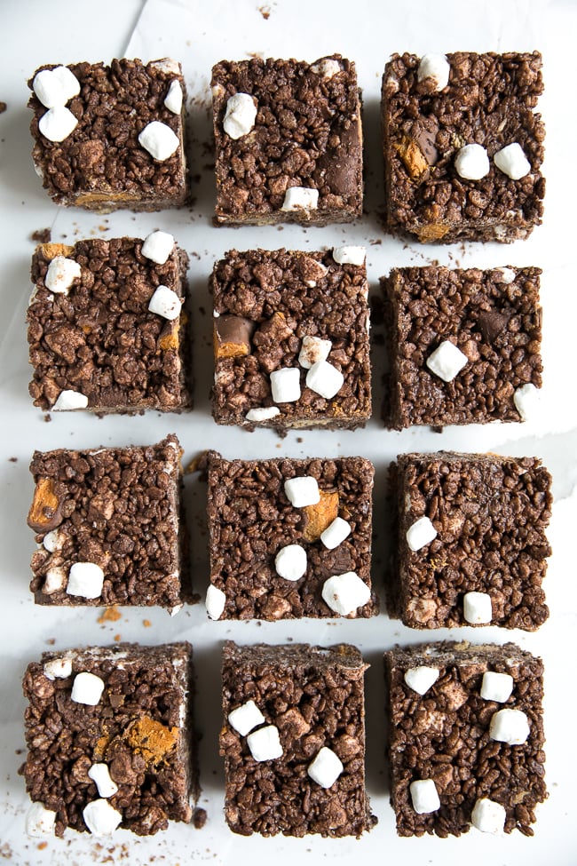 These Butterfinger Chocolate Rice Krispie Treats are a delicious twist on the classic Rice Krispie treat bar, but filled with chocolate and peanut butter!