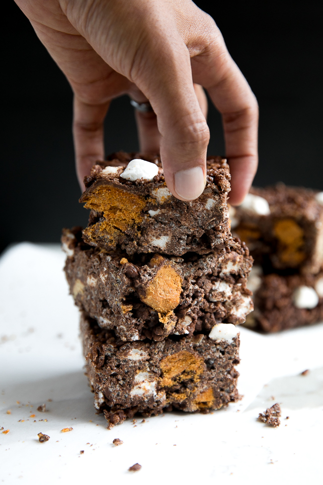 These Butterfinger Chocolate Rice Krispie Treats are a delicious twist on the classic Rice Krispie treat bar, but filled with chocolate and peanut butter!