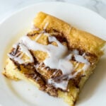 This super easy Cinnamon Roll Sheet Cake is a perfect dessert for potlucks or parties! So easy and seriously so delicious!