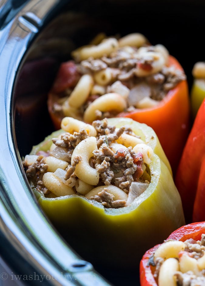 These Stuffed Bell Peppers are filled with ground beef and macaroni and cheese, then slow cooked to perfection! Such an easy weeknight dinner recipe!