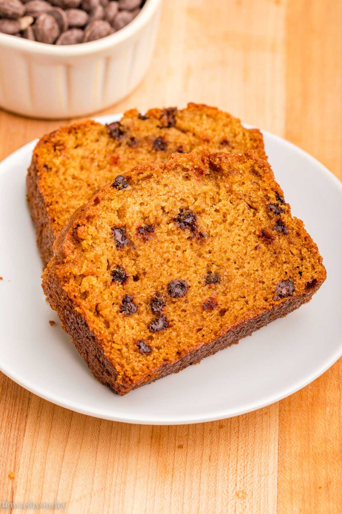 Slices of pumpkin chocolate chip loaves on white plate. 