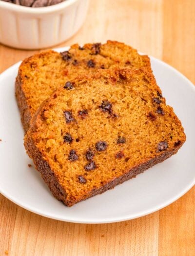 Slices of Pumpkin Chocolate Chip loaf on white plate.