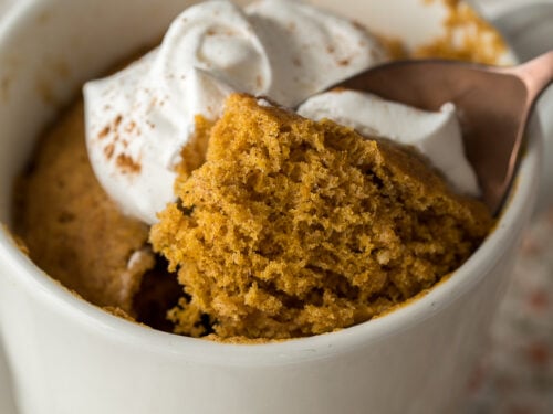 This delightful mug cake is filled with pumpkin spice and topped with whipped cream!