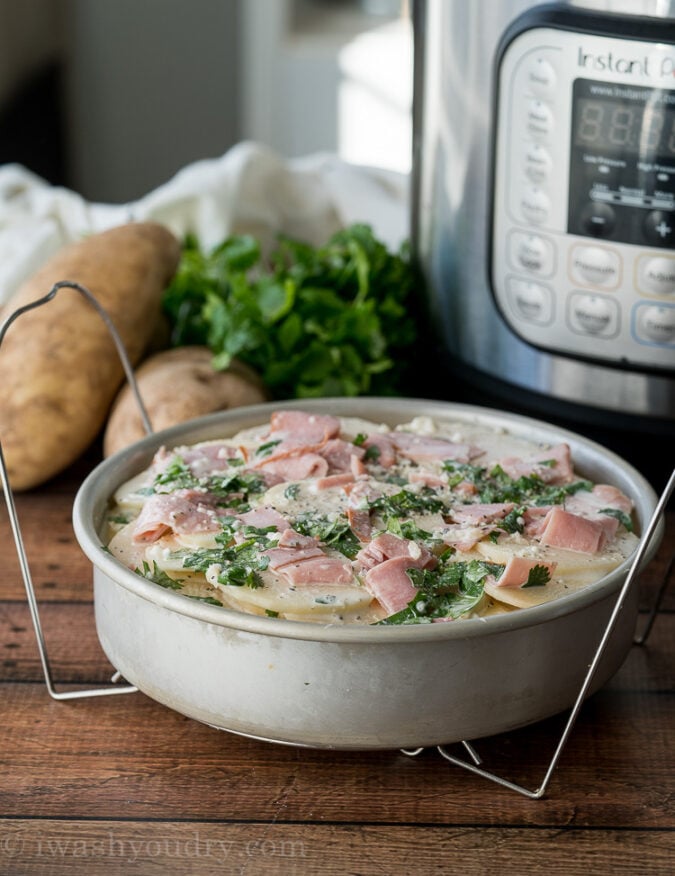 Start by layering your potatoes, ham and creamy sauce in a dish that can fit inside your Instant Pot. 