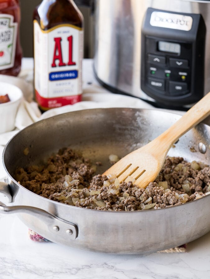 Start by browning some beef in a skillet with onions to make this Crock Pot Baked Beans recipe.