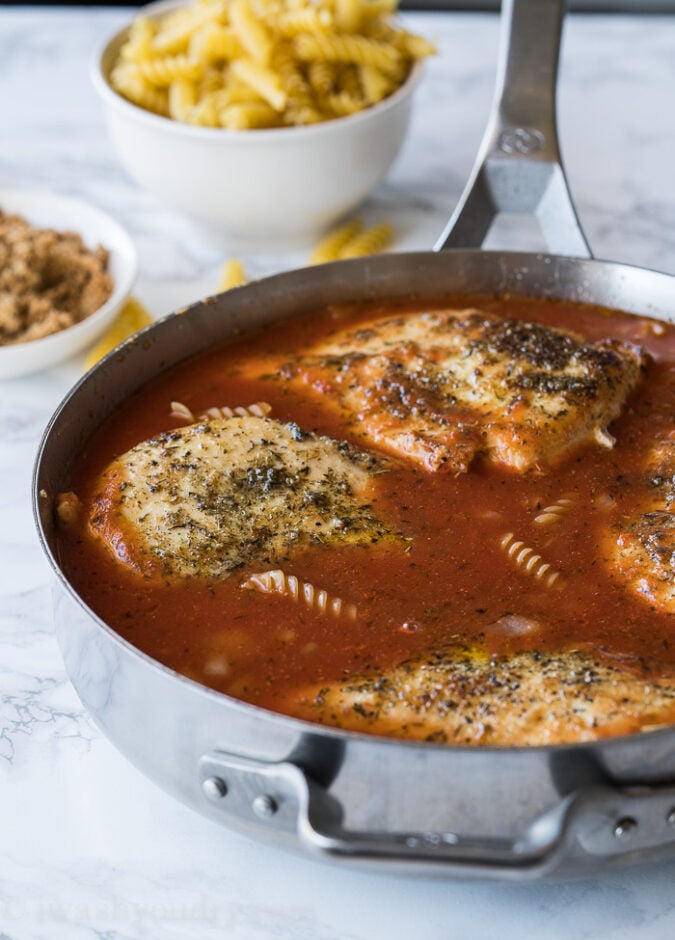 Simmer the pasta sauce, uncooked noodles and seared chicken in a skillet until the chicken is cooked through and the pasta is tender.