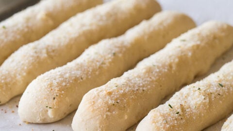 These 2 ingredient dough Garlic Breadsticks are just 1 weight watcher freestyle point each! So easy to make and seriously SO GOOD!