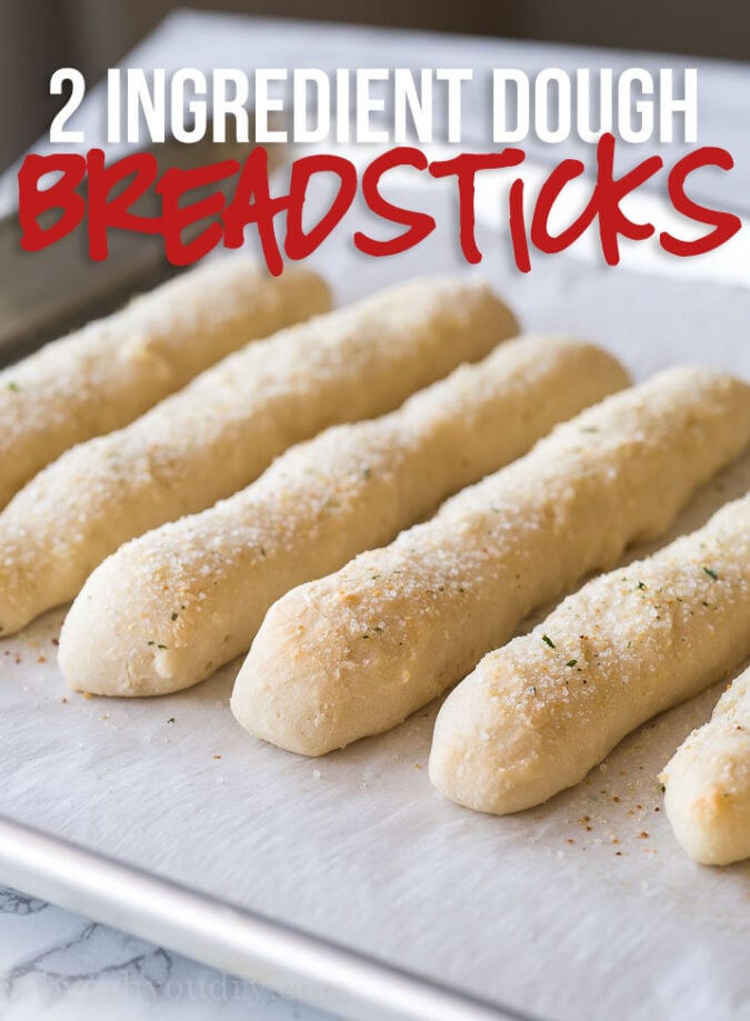 These 2 ingredient dough Garlic Breadsticks are just 1 weight watcher freestyle point each! So easy to make and seriously SO GOOD!