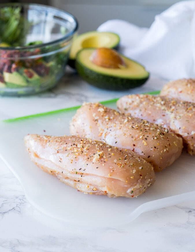 Season your chicken breast with a blend of pantry seasonings and make a pocket on the side of each breast to hold the avocado filing.