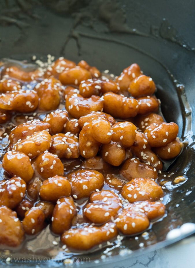 The sauce on this Crispy Sesame Popcorn Shrimp is AMAZING! It's sweetened with honey and brown sugar! Even my kids LOVED it!