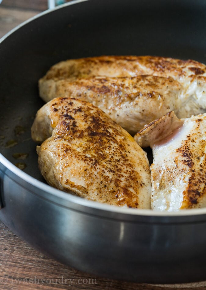 Season three large chicken breasts and sear in a large skillet until browned on each side.