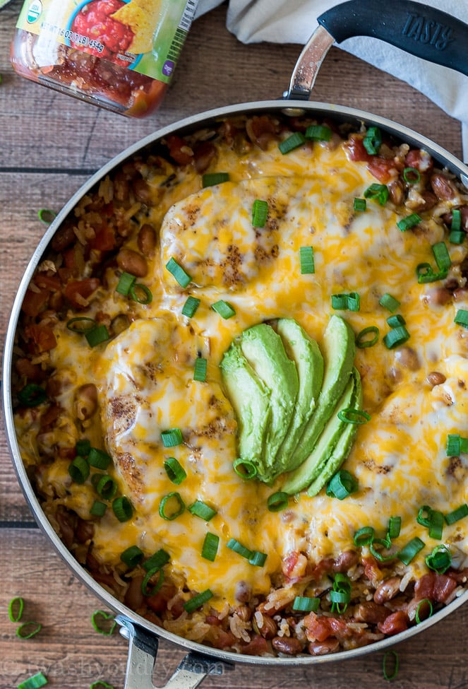 Top the chicken breasts with lots of cheese then cover and let it melt. Once melted top with additional salsa, sliced avocado and diced green onions.