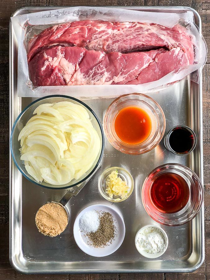 A tray filled with different types of food, with Pork