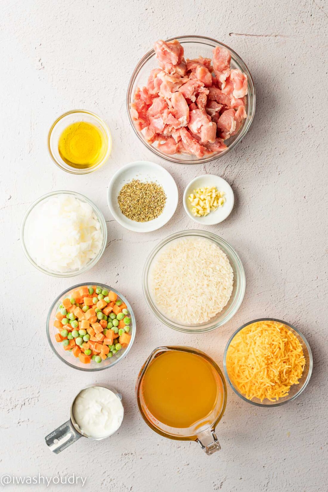 Ingredients for Cheesy Pork and Rice in glass bowls. 