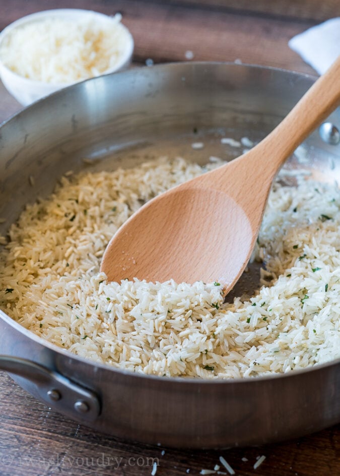 Start by toasting the uncooked rice in olive oil and butter along with some garlic powder and dried parsley. 