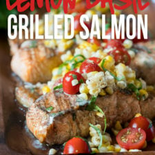 This Lemon Basil Grilled Salmon is topped with a lemon and basil infused butter and a grilled corn and tomato salad that's so fresh and delicious!