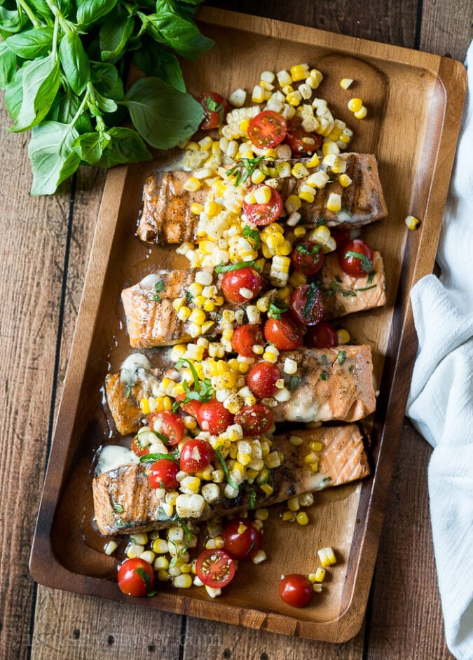This perfectly grilled Salmon with Lemon Basil butter and grilled corn and tomato salad is a complete meal that my whole family LOVES!