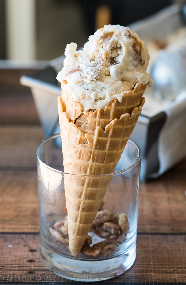 Cool off with this super smooth and creamy Homemade Ice Cream Recipe that's filled with ribbons of caramel and chunks of candied pecans!