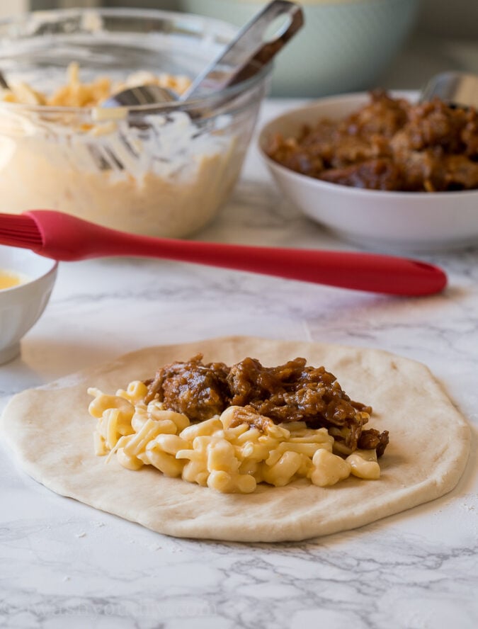 Combine macaroni and cheese with shredded bbq pork for the ultimate calzone recipe!