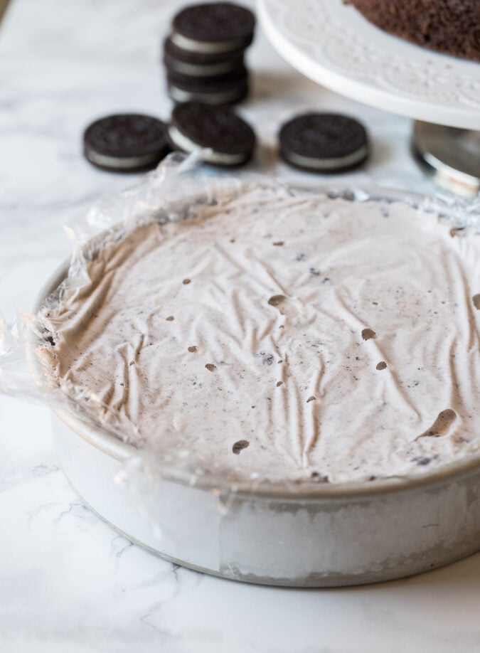 Start by freezing your favorite flavor of ice cream in a round cake pan that's the same size as your cake.