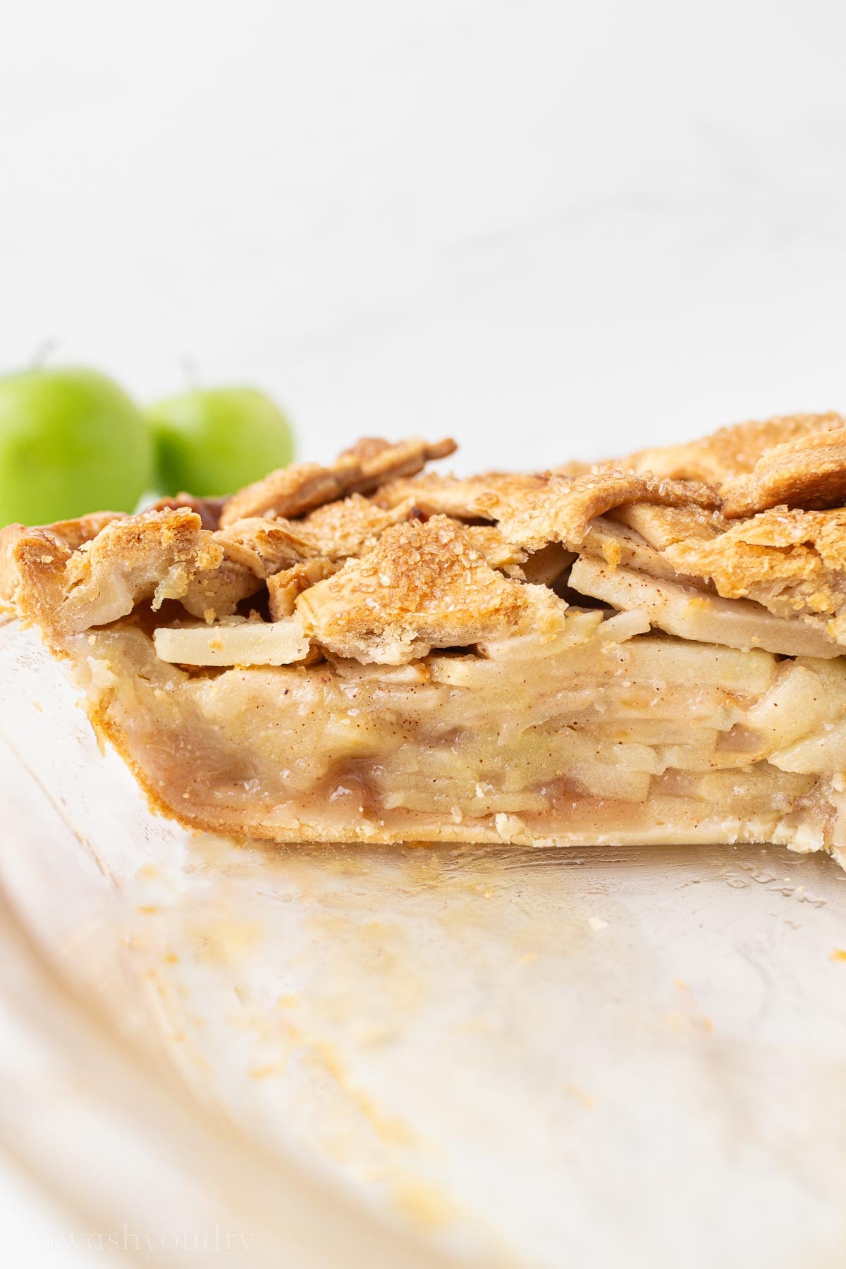 sliced apple pie in pie plate.