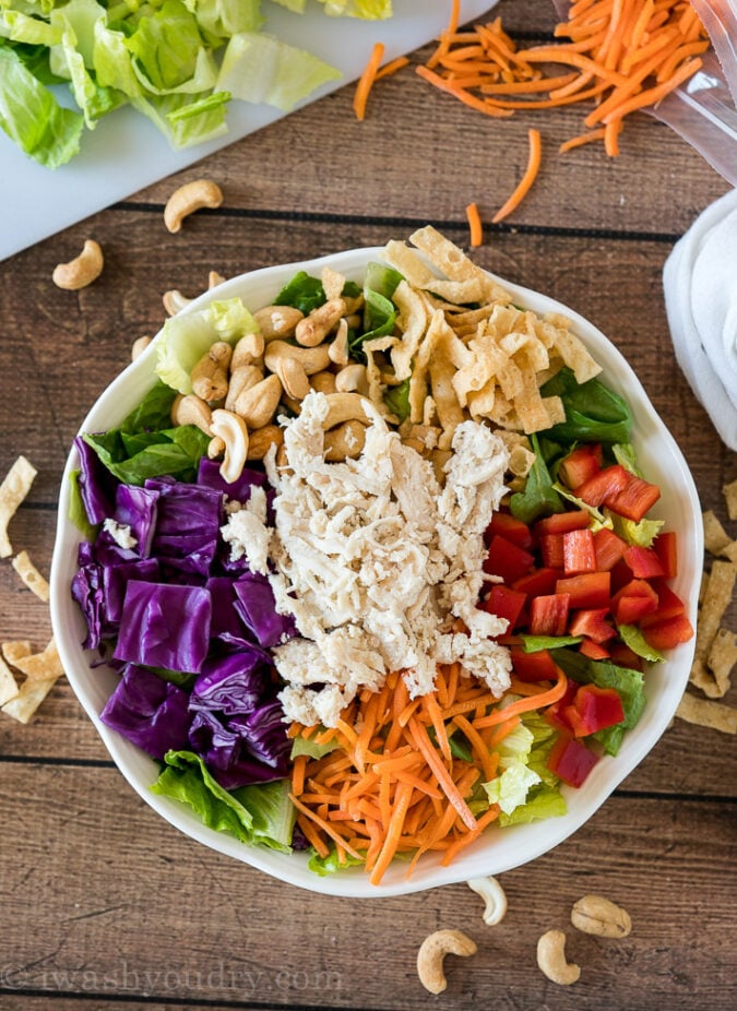 By placing the colorful ingredients around the bowl it makes it more attractive and fun to eat! Your kids will LOVE this Asian Chicken Salad!