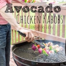 A person grilling skewered of Avocado Chicken Kabobs on a BBQ grill