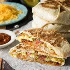 A close up of a breakfast Crunchwrap cut in half and stacked on top of each other