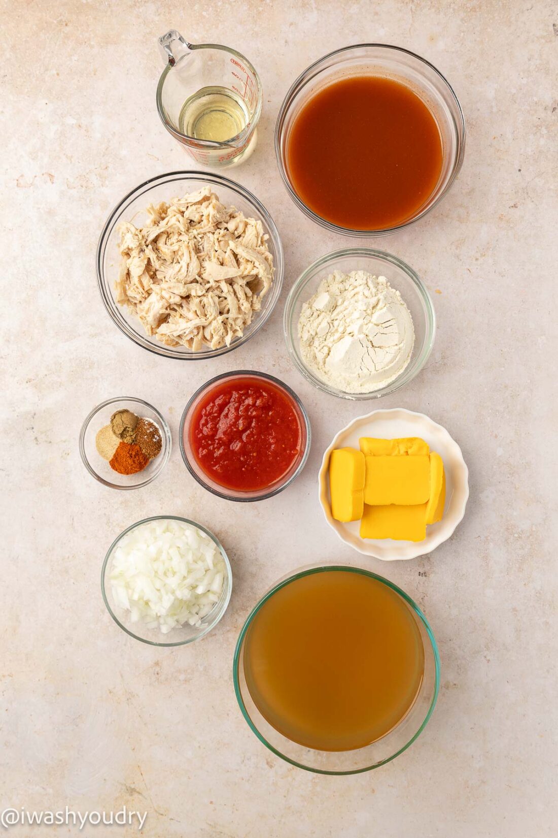ingredients for soup on a white surface with chicken.