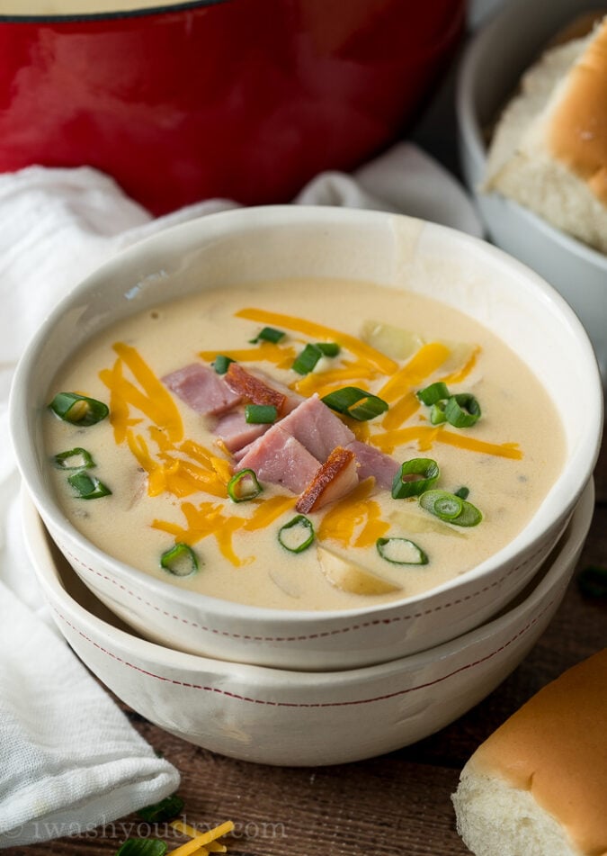 YUM! This super easy Ham and Potato Soup recipe is ready in less than 30 minutes for an easy weeknight dinner!