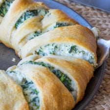 A close up of some present bread stuffed with a creamy cheese spinach