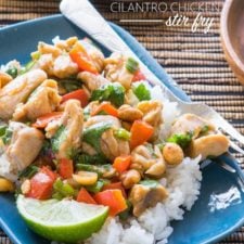A plate of food on a plate, with rice, chicken and stir fry veggies