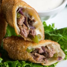A close up of a Philly Cheese Steak Egg Roll split in half to show the insides