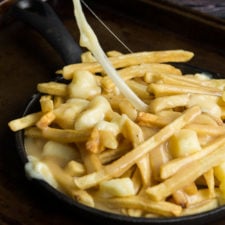 A skillet of french fries in Poutine Gravy