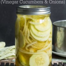 A close upon pickled cucumbers and onions in a clear glass jar