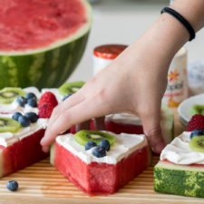 Food on a table, with watermelon fruit pizza