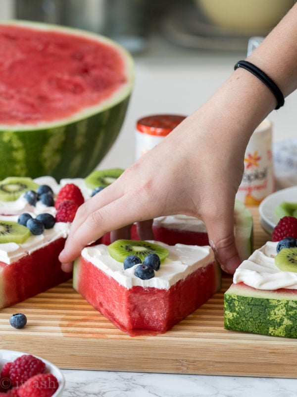 Food on a table, with watermelon fruit pizza
