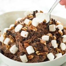 A bowl of food, with chocolate cheesecake salad topped with mini marshmallows