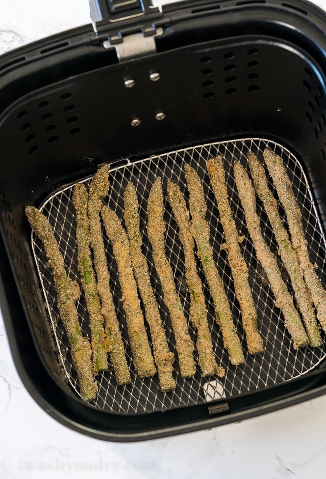 You'll want to make sure your asparagus is in an even layer in the air fryer, leaving just enough room between the spears so they don't touch. 