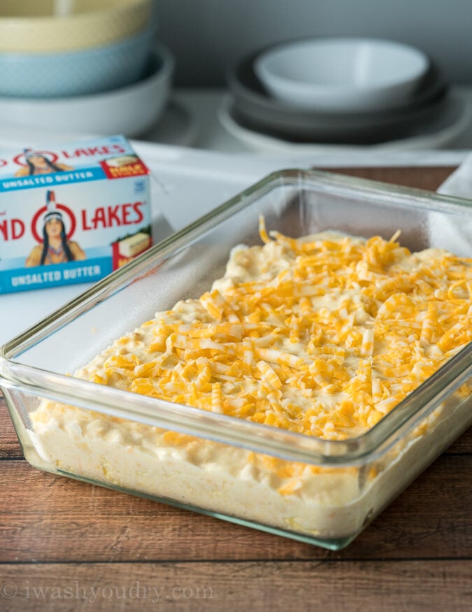 Top the casserole with shredded cheese before baking.