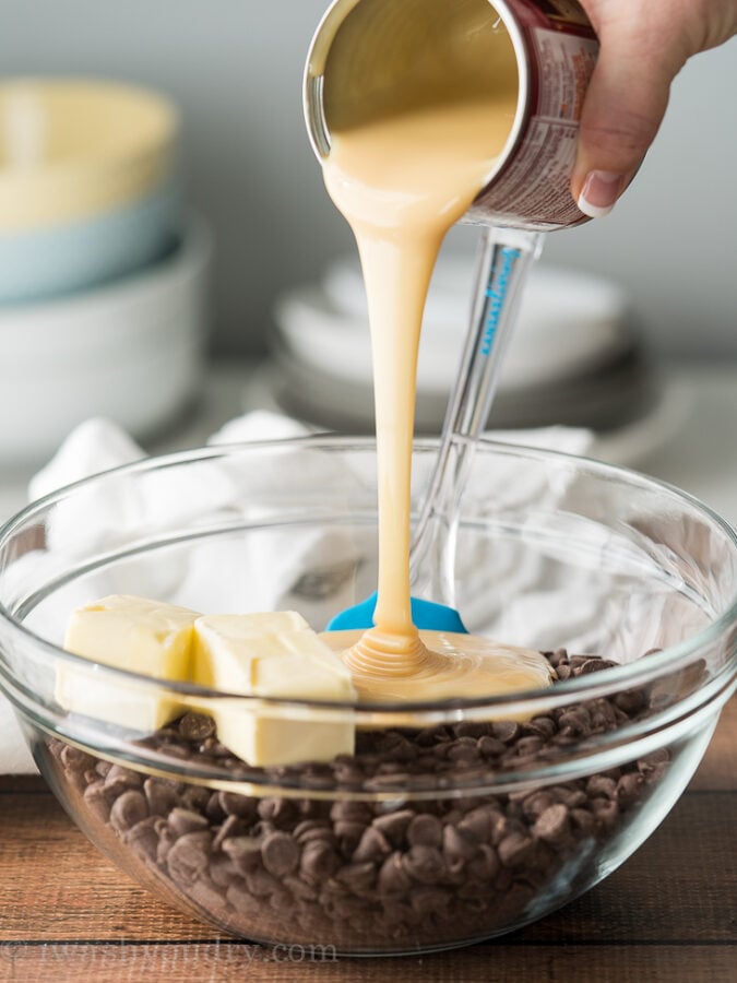 Combine some chocolate chips, butter and sweetened condensed milk in a microwave safe dish and melt to make this super easy Last Minute Fudge Recipe!