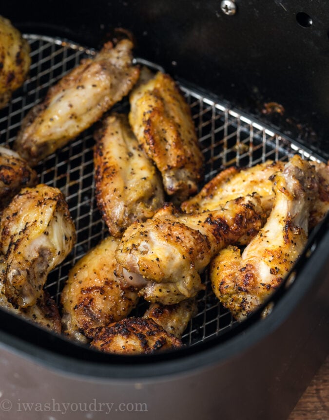 A pan of food on a grill, with Chicken and Lemon pepper