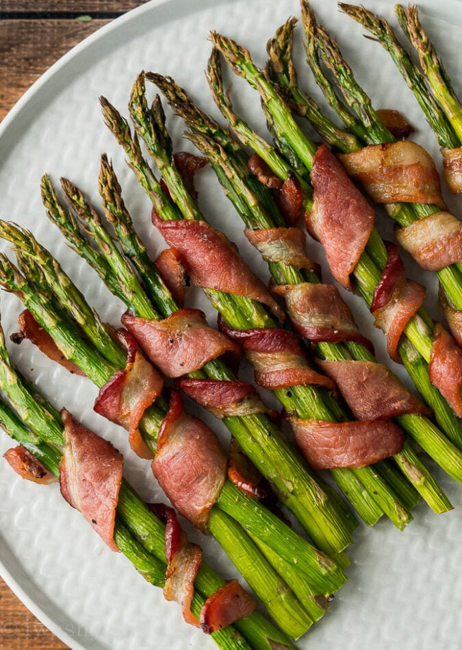 crispy bacon wrapped asparagus spears on plate.