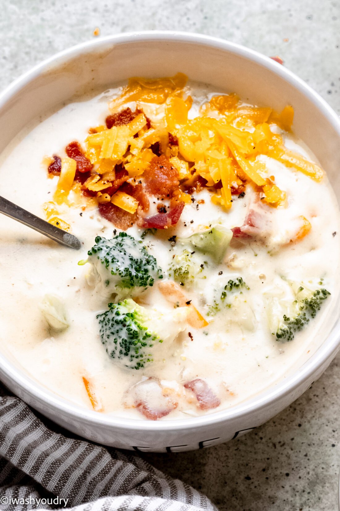 bowl of soup with broccoli, cheese and bacon.