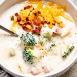bowl of soup with broccoli, cheese and bacon.