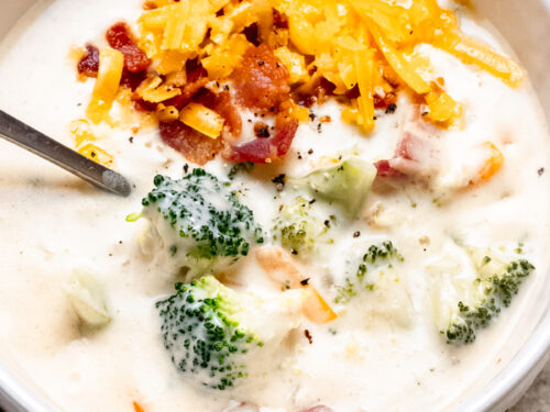 bowl of soup with broccoli, cheese and bacon.