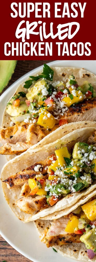 This super easy Grilled Chicken Tacos Recipe is perfectly seasoned and topped with a delicious and fresh mango avocado salsa!