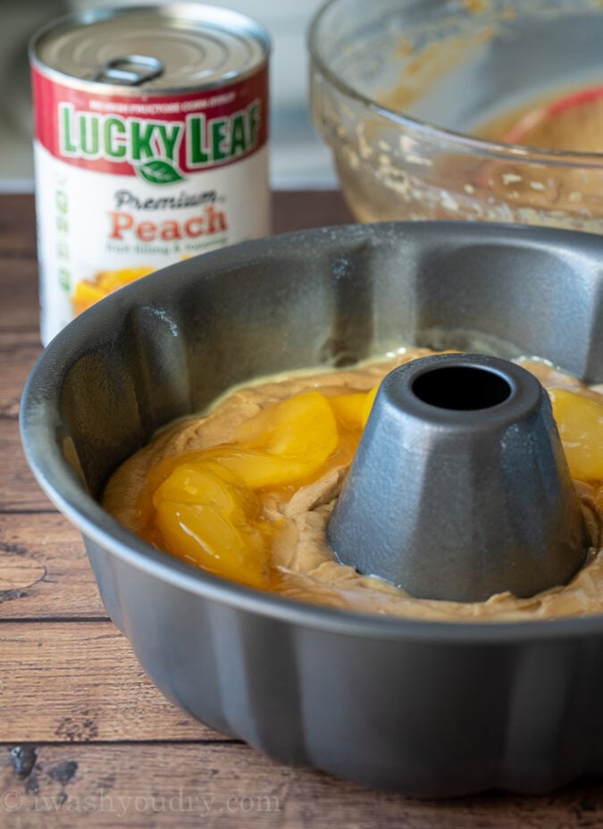 Spoon the peach pie filling into the center of the spice cake